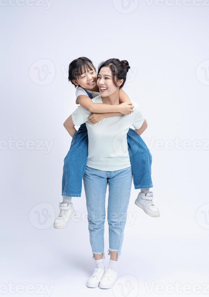 Image of Asian mother and daughter on background photo