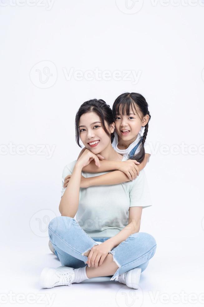 Image of Asian mother and daughter on background photo