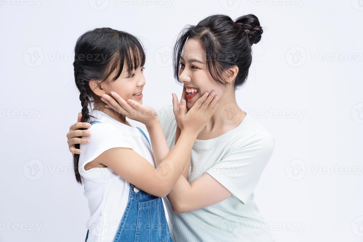 Image of Asian mother and daughter on background photo