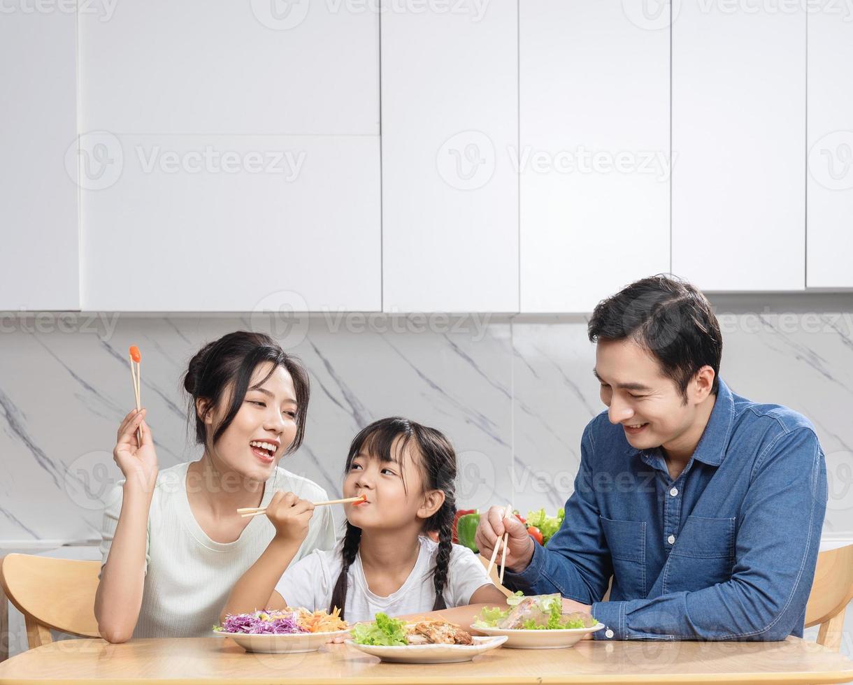 Image of Asian family in the kitchen photo