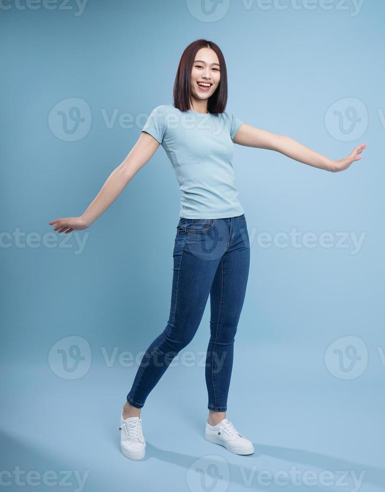 Image of young Asian woman posing on background photo