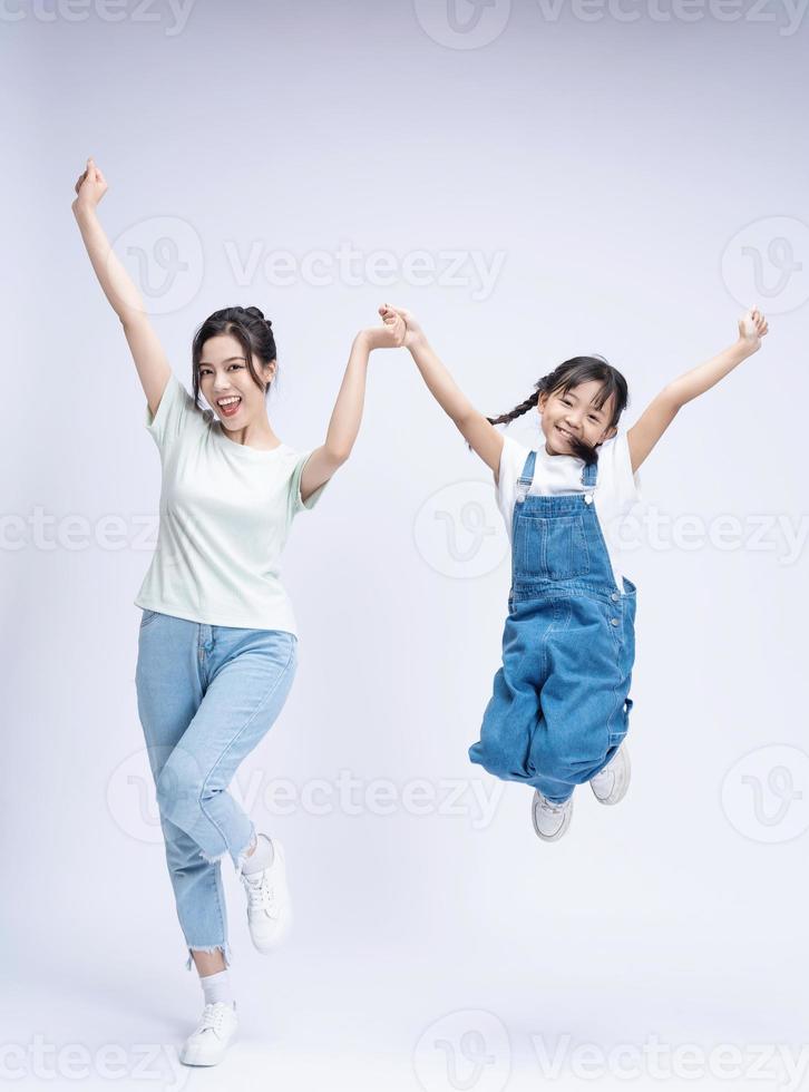 Image of Asian mother and daughter on background photo