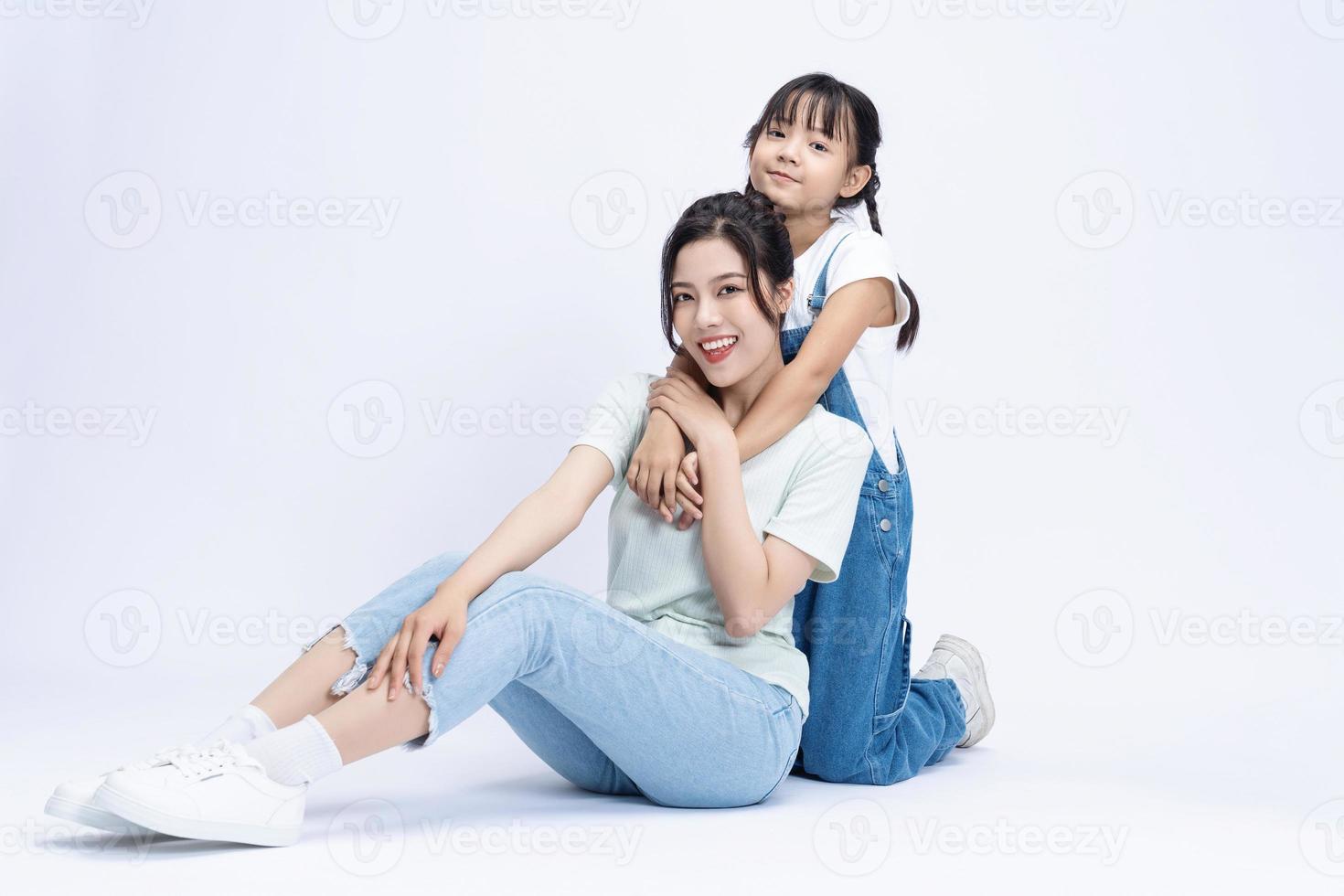 Image of Asian mother and daughter on background photo