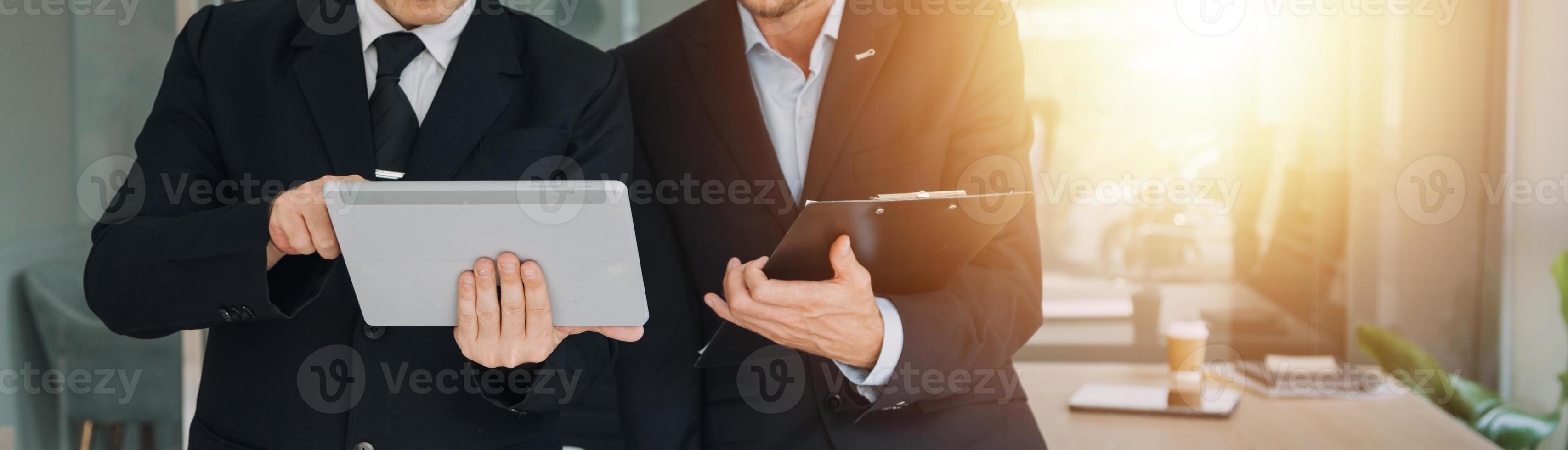Financial analysts analyze business financial reports on a digital tablet planning investment project during a discussion at a meeting of corporate showing the results of their successful teamwork. photo