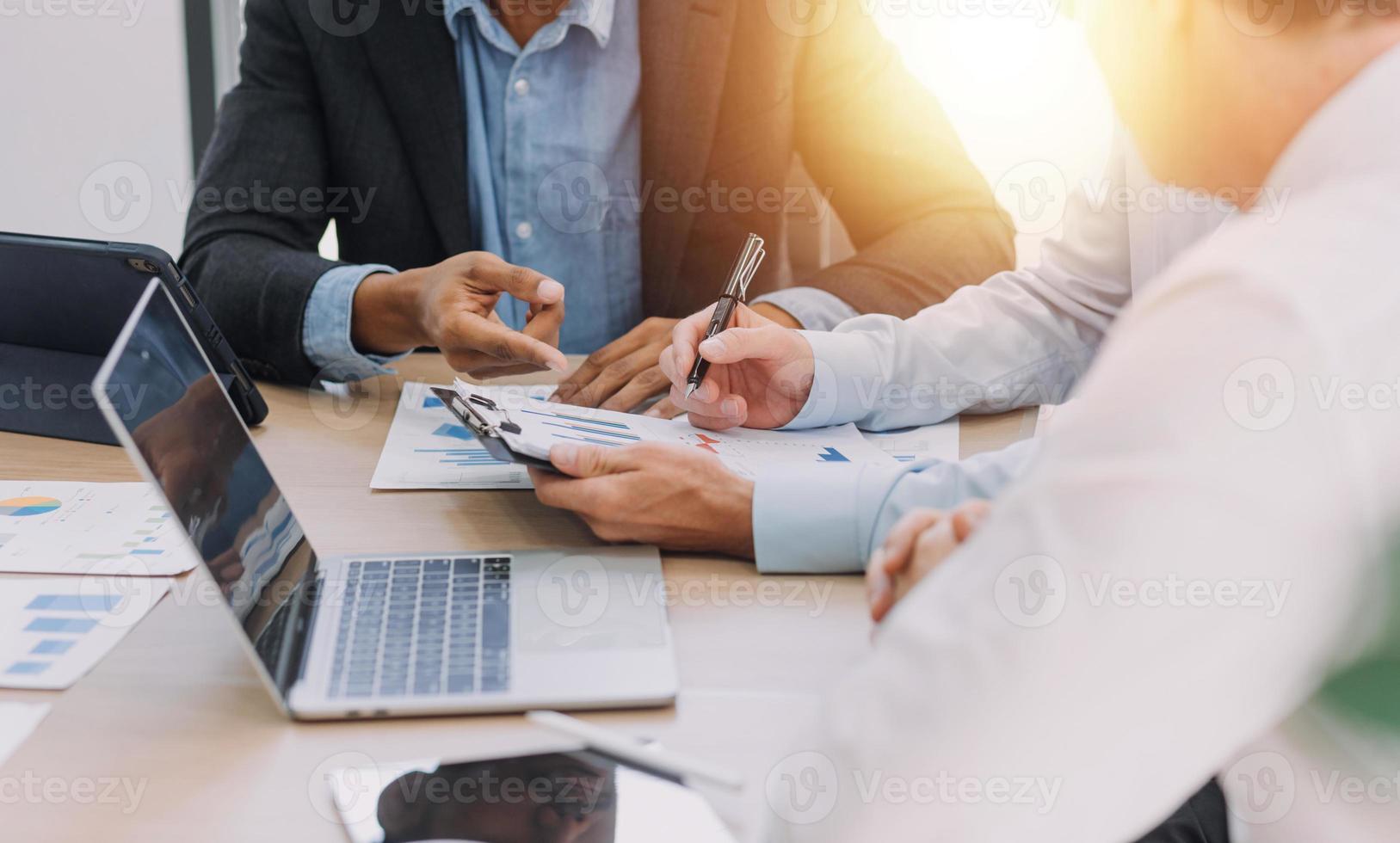 Financial analysts analyze business financial reports on a digital tablet planning investment project during a discussion at a meeting of corporate showing the results of their successful teamwork. photo