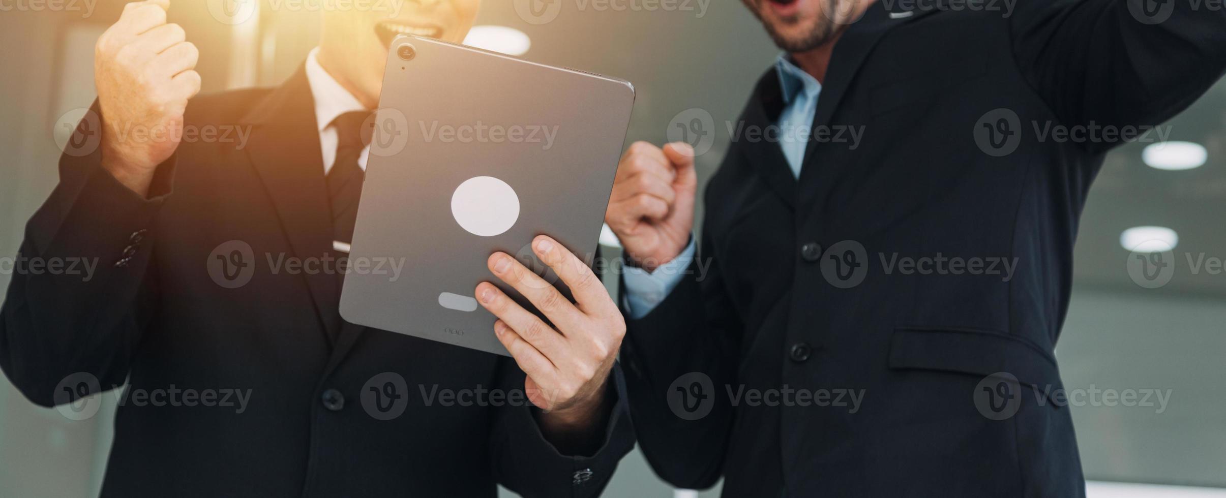 Financial analysts analyze business financial reports on a digital tablet planning investment project during a discussion at a meeting of corporate showing the results of their successful teamwork. photo