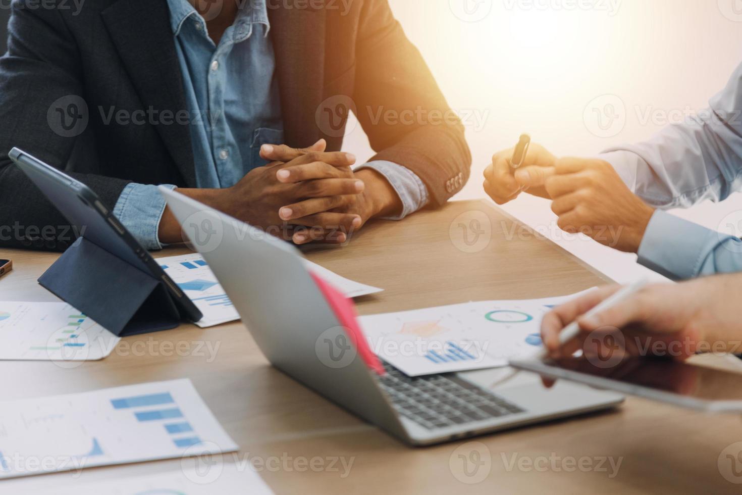 Financial analysts analyze business financial reports on a digital tablet planning investment project during a discussion at a meeting of corporate showing the results of their successful teamwork. photo