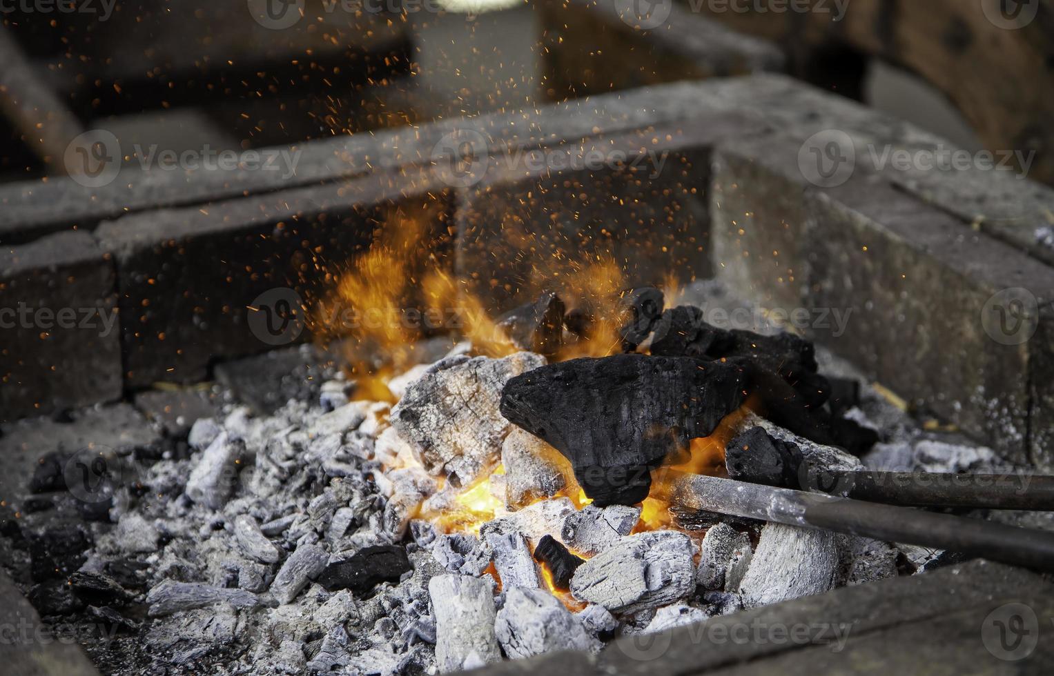 Burning coal in a forge photo