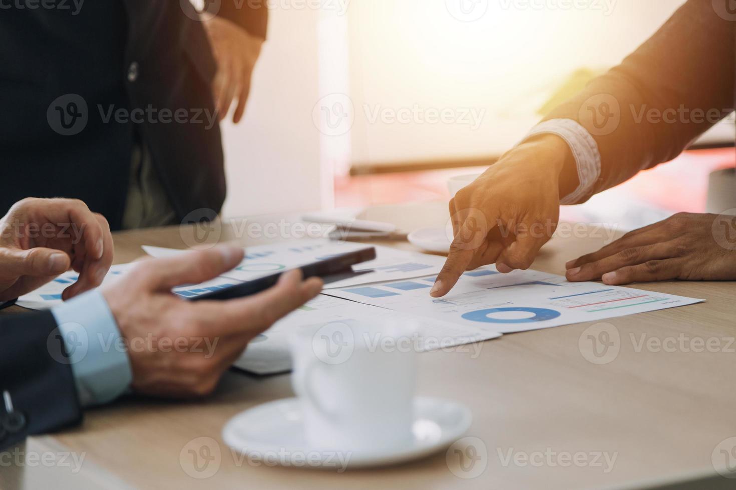 Financial analysts analyze business financial reports on a digital tablet planning investment project during a discussion at a meeting of corporate showing the results of their successful teamwork. photo