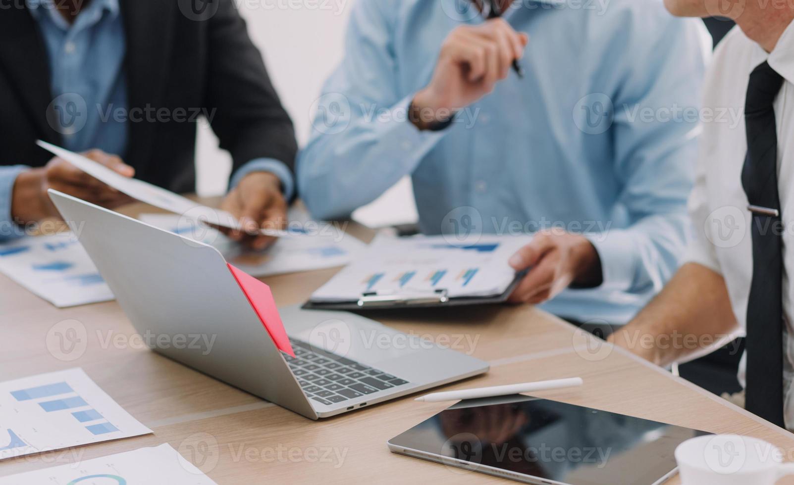 Financial analysts analyze business financial reports on a digital tablet planning investment project during a discussion at a meeting of corporate showing the results of their successful teamwork. photo