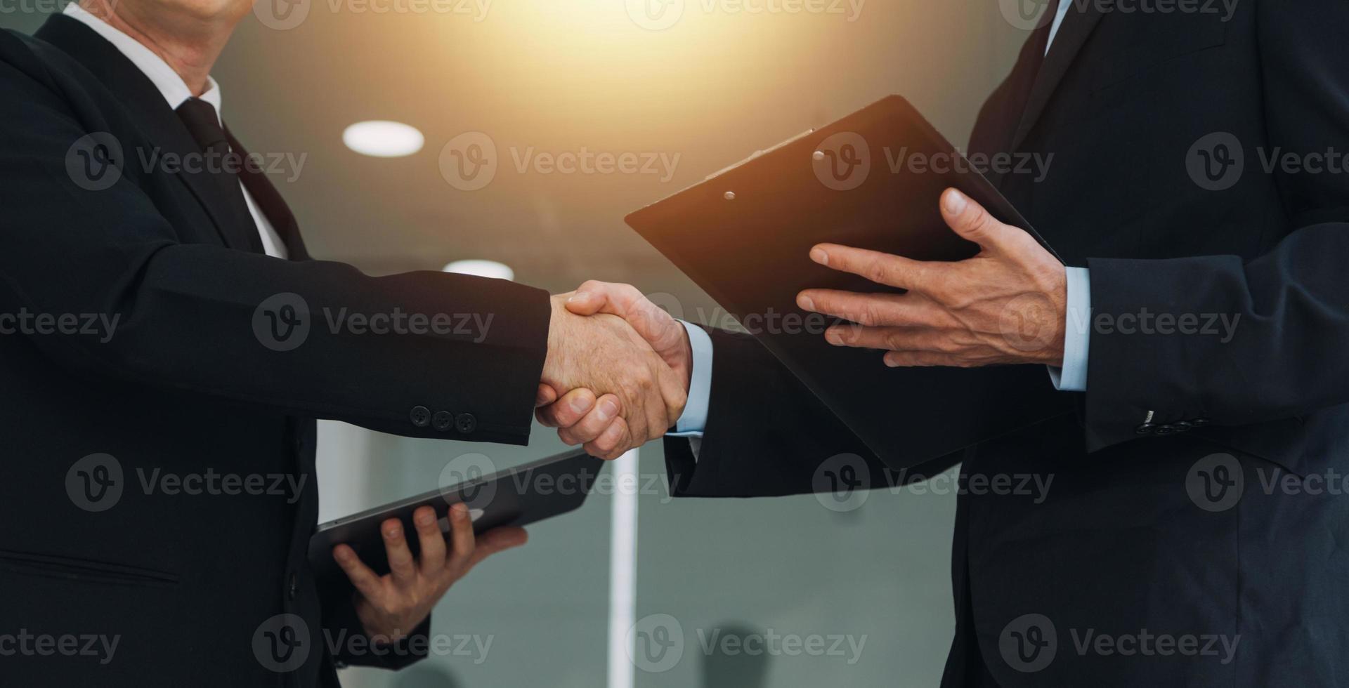 Financial analysts analyze business financial reports on a digital tablet planning investment project during a discussion at a meeting of corporate showing the results of their successful teamwork. photo