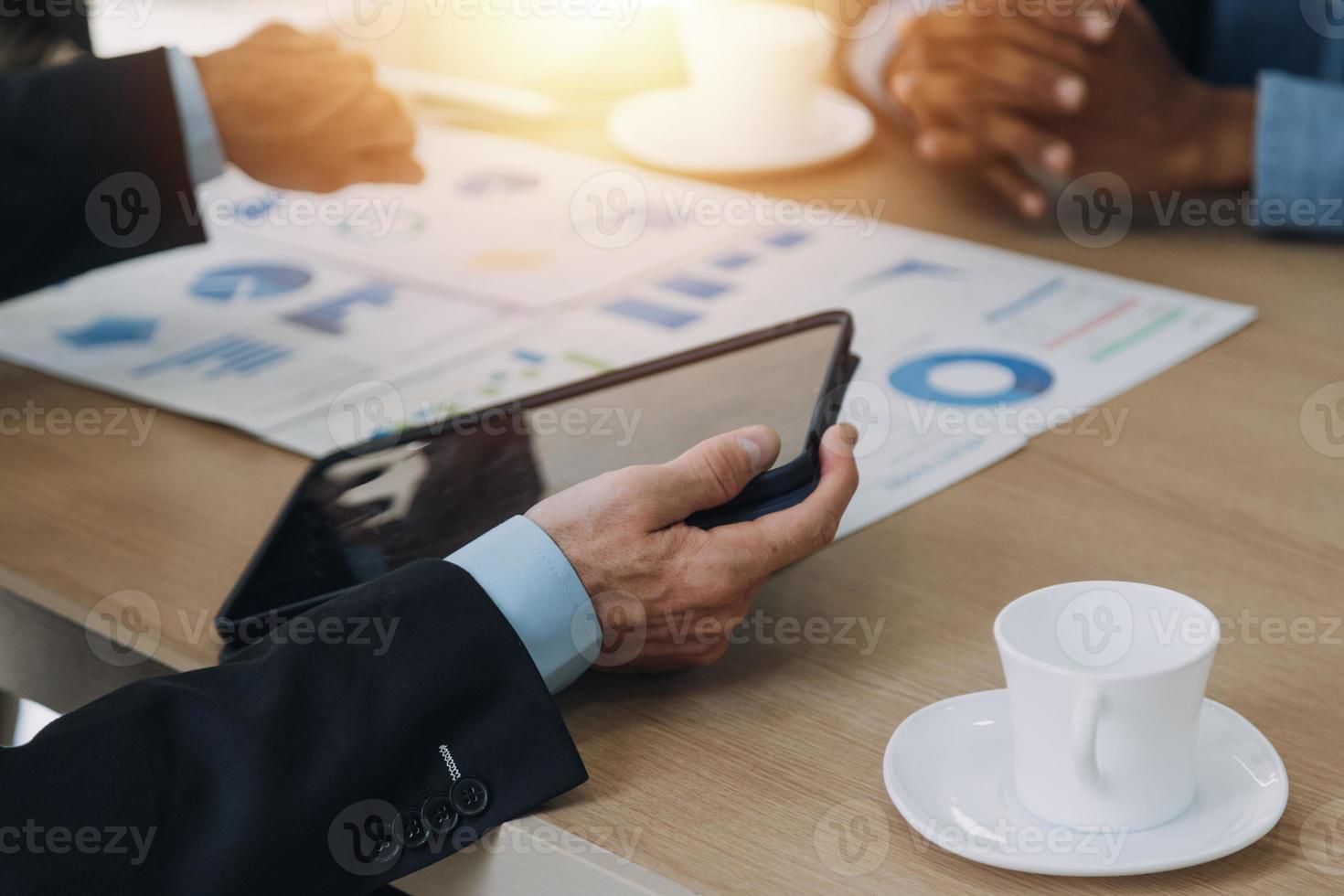 Financial analysts analyze business financial reports on a digital tablet planning investment project during a discussion at a meeting of corporate showing the results of their successful teamwork. photo