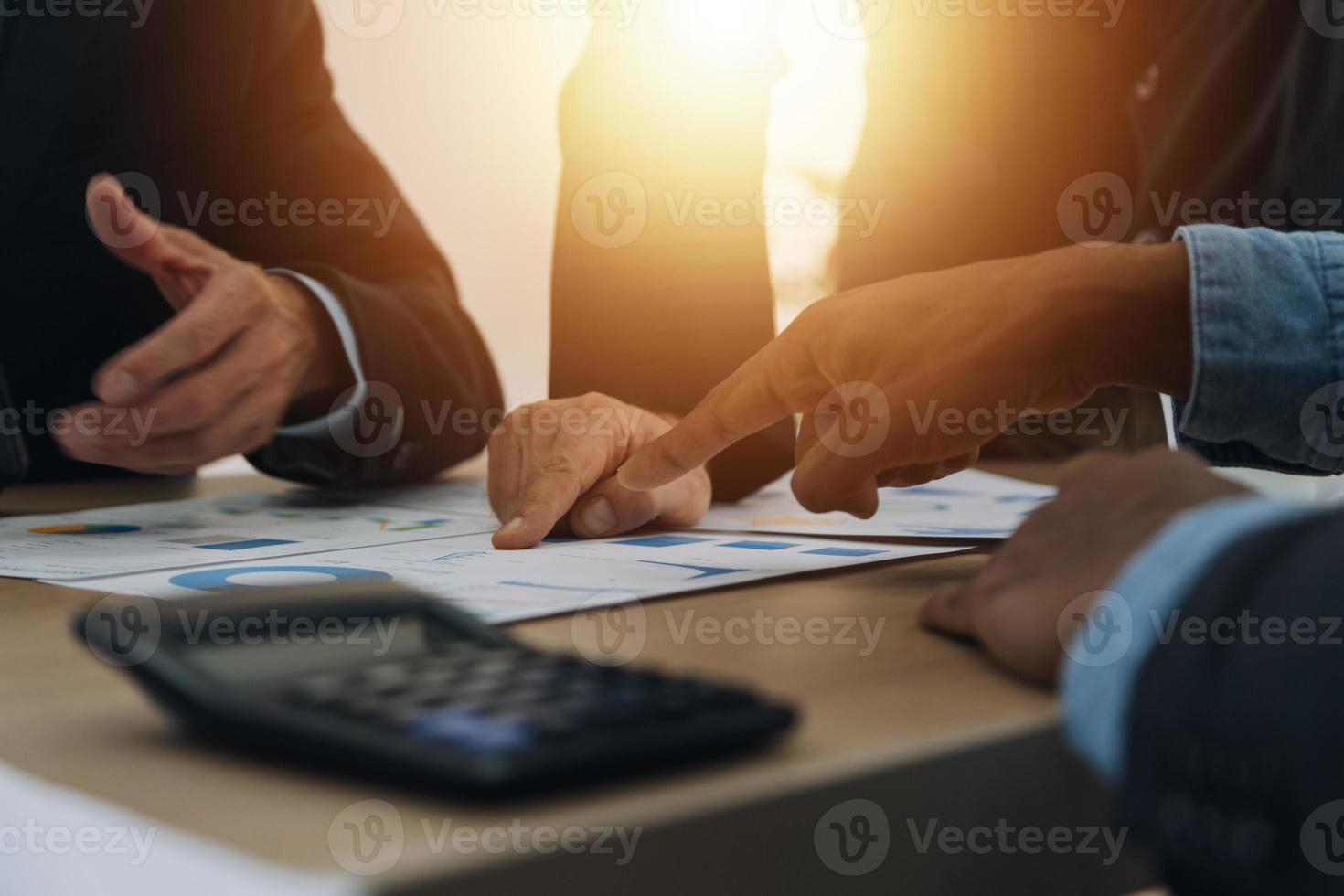 Financial analysts analyze business financial reports on a digital tablet planning investment project during a discussion at a meeting of corporate showing the results of their successful teamwork. photo