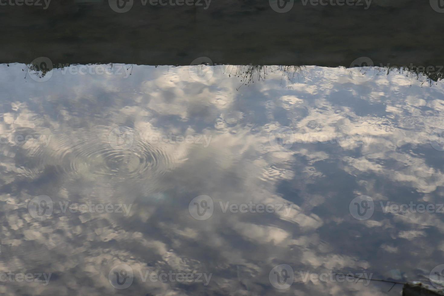white clouds and sun against a background of blue sky photo