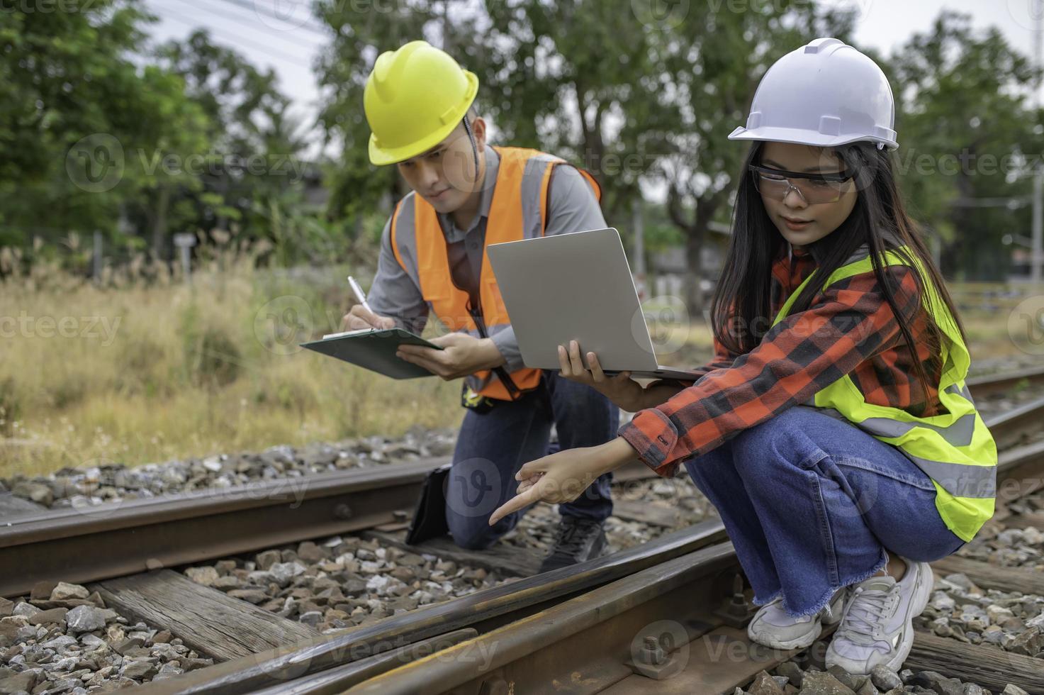 Two engineer working at train station,Work together happily,Help each other analyze the problem,Consult about development guidelines photo