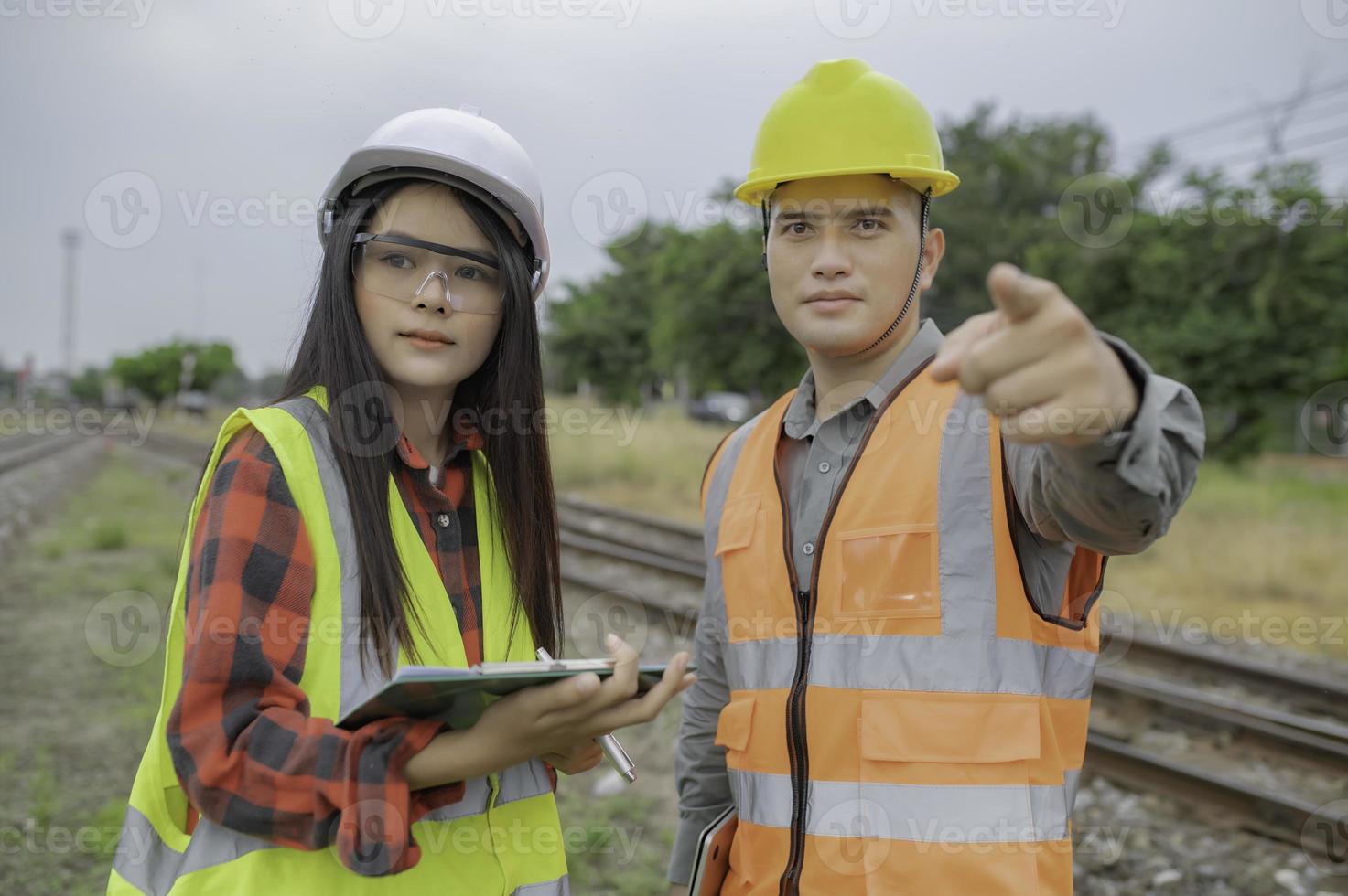 Two engineer working at train station,Work together happily,Help each other analyze the problem,Consult about development guidelines photo