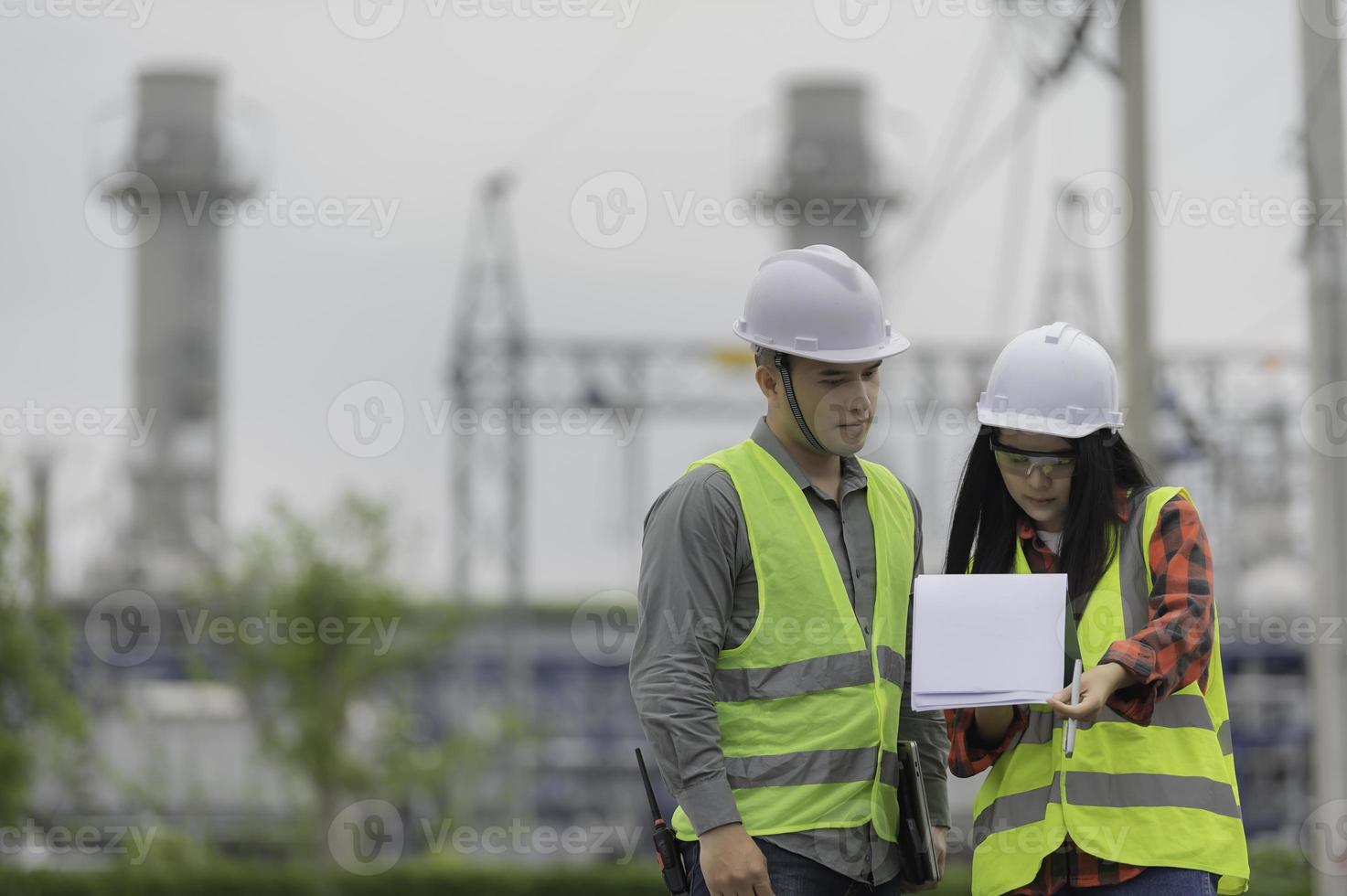 Two engineer working at power plant,Work together happily,Help each other analyze the problem,Consult about development guidelines photo