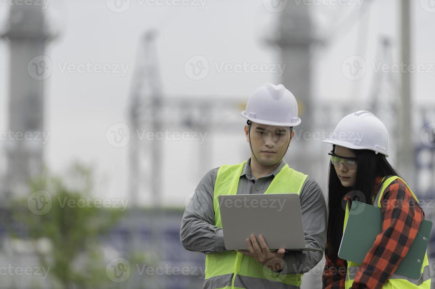 Two engineer working at power plant,Work together happily,Help each other analyze the problem,Consult about development guidelines photo