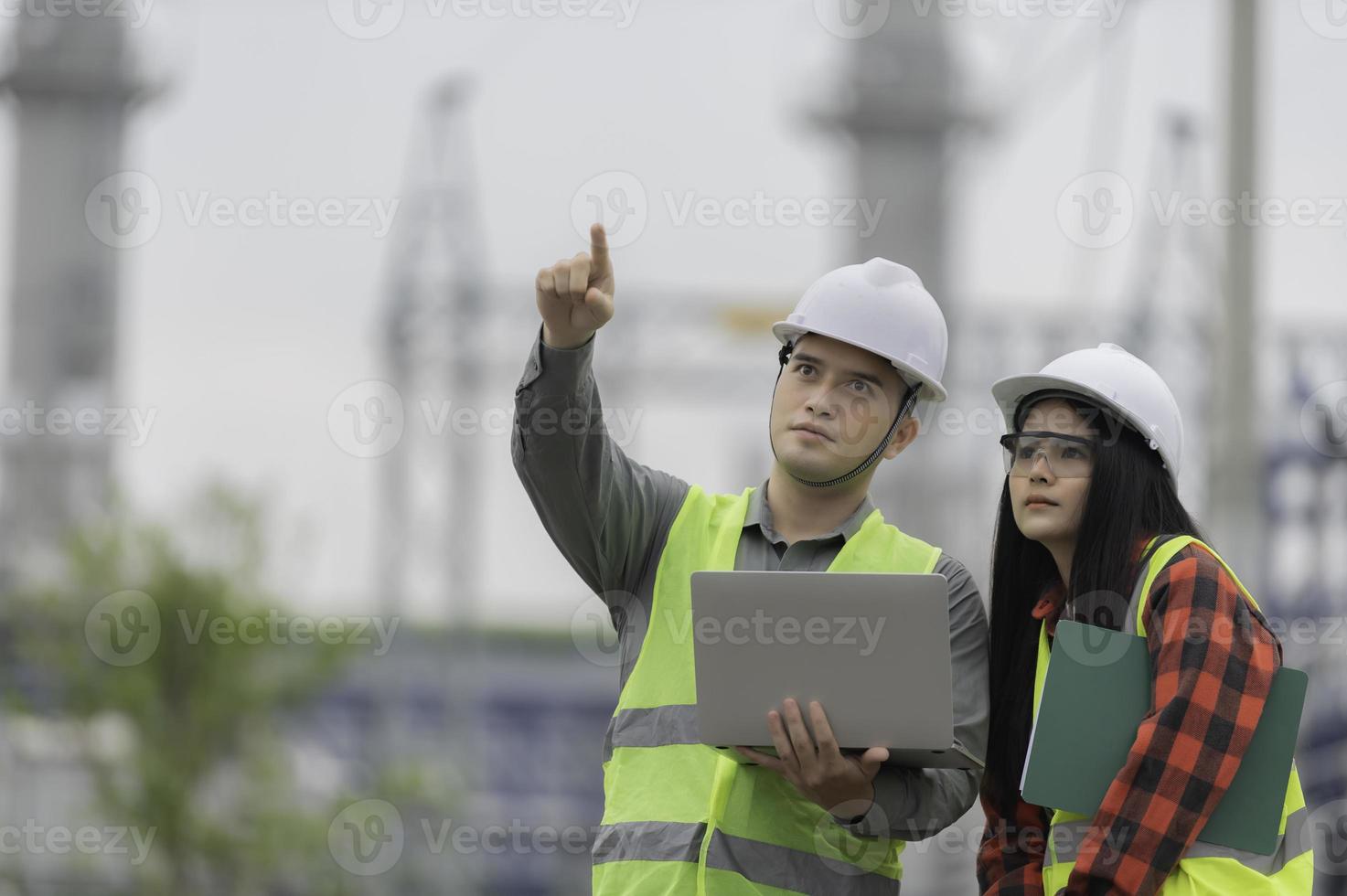Two engineer working at power plant,Work together happily,Help each other analyze the problem,Consult about development guidelines photo