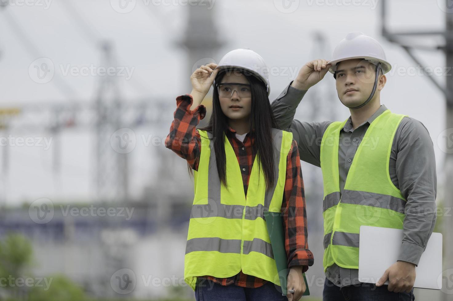 Two engineer working at power plant,Work together happily,Help each other analyze the problem,Consult about development guidelines photo