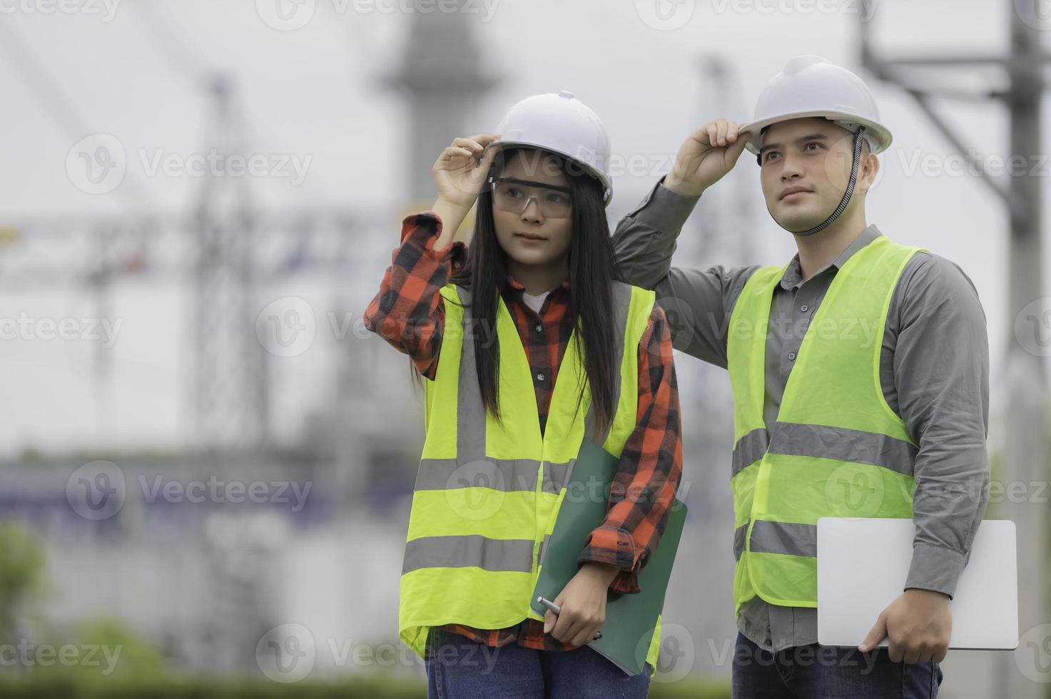 Two engineer working at power plant,Work together happily,Help each other analyze the problem,Consult about development guidelines photo