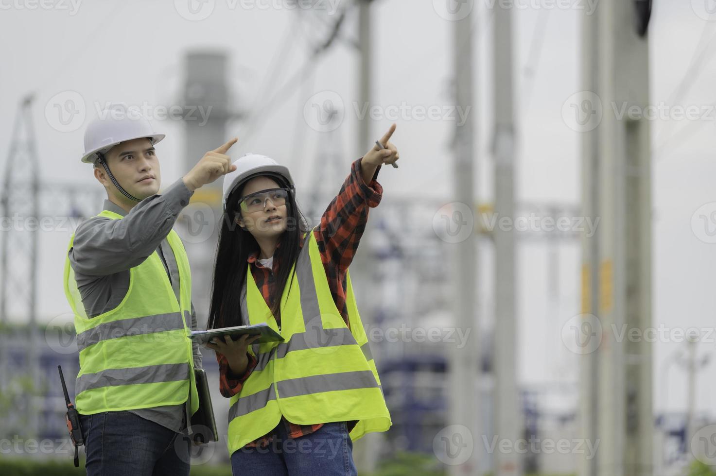 Two engineer working at power plant,Work together happily,Help each other analyze the problem,Consult about development guidelines photo