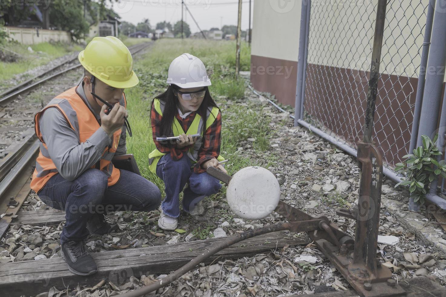 Two engineer working at train station,Work together happily,Help each other analyze the problem,Consult about development guidelines photo