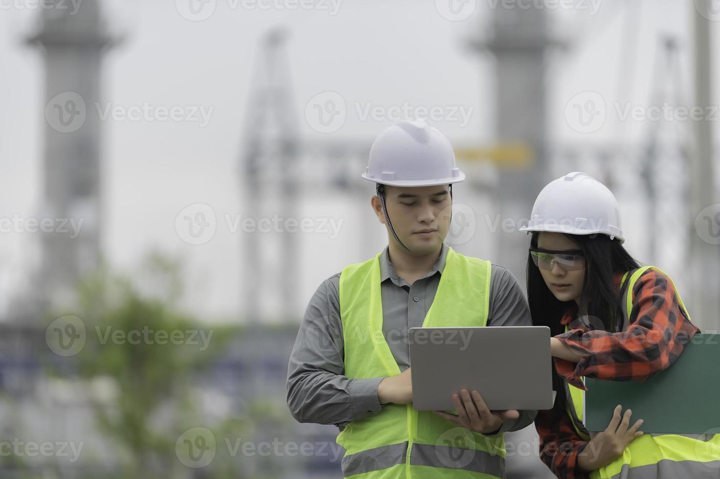 Two engineer working at power plant,Work together happily,Help each other analyze the problem,Consult about development guidelines photo