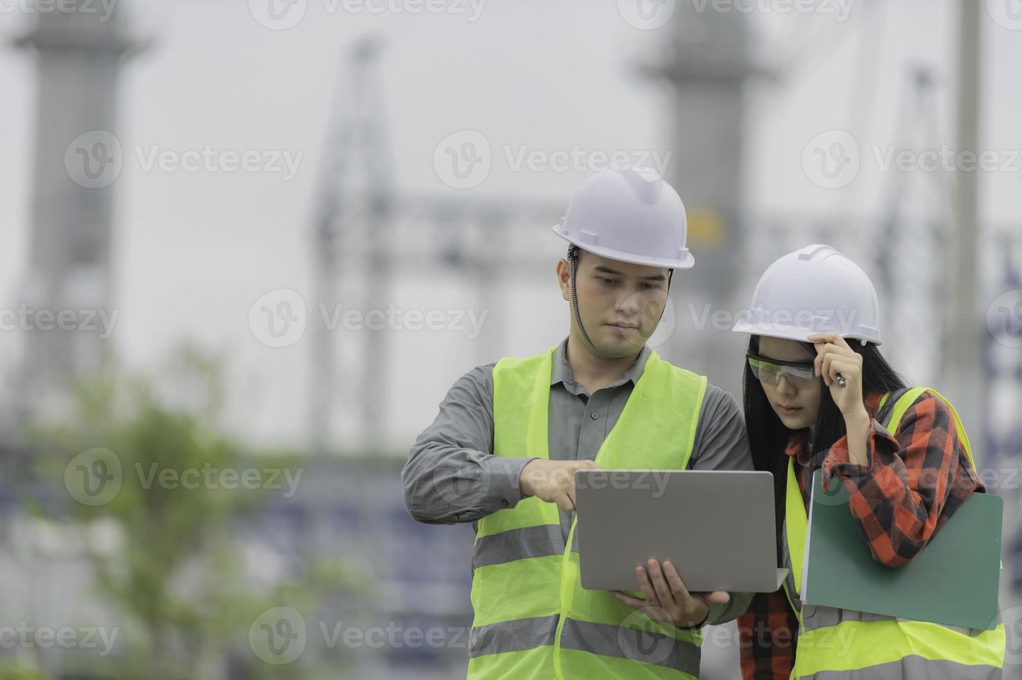 Two engineer working at power plant,Work together happily,Help each other analyze the problem,Consult about development guidelines photo
