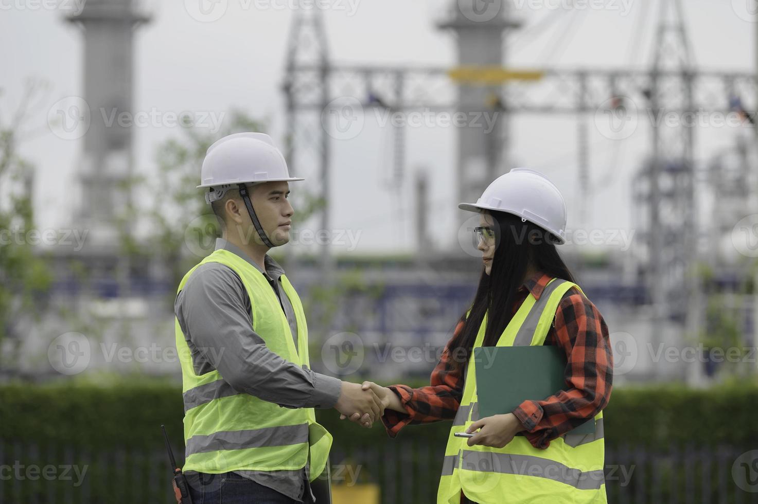 Two engineer working at power plant,Work together happily,Help each other analyze the problem,Consult about development guidelines photo