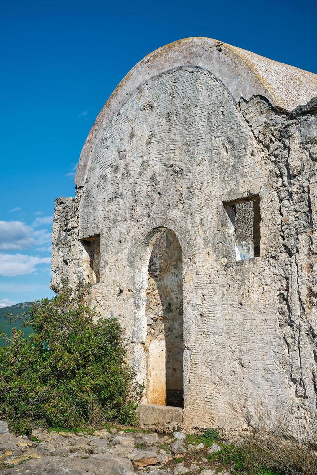 old Greek chapel in an abandoned ghost town near Fethiye in Turkey. Site of the ancient Greek city of Karmilissos from the 18th century. photo