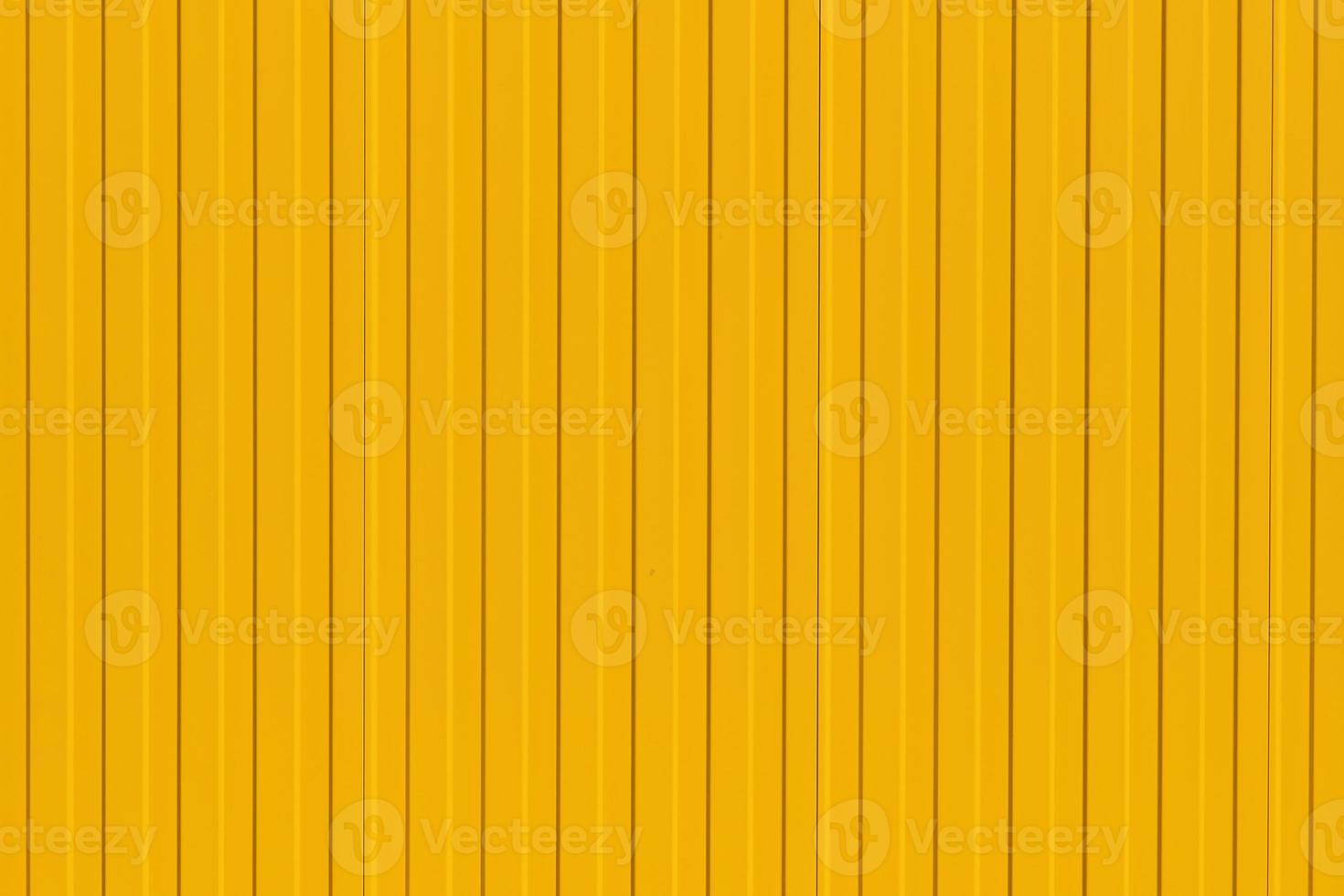 Bright yellow profiled metal wall, fence or warehouse idea, background for screen or design ideas photo