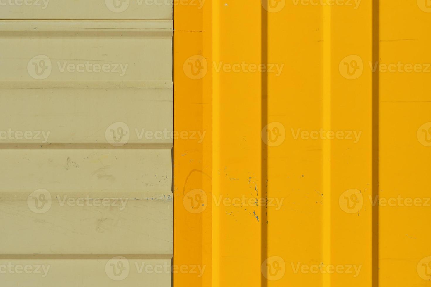 Gray and bright yellow warehouse wall made of profiled metal wall, background ideas for a screen or design articles photo