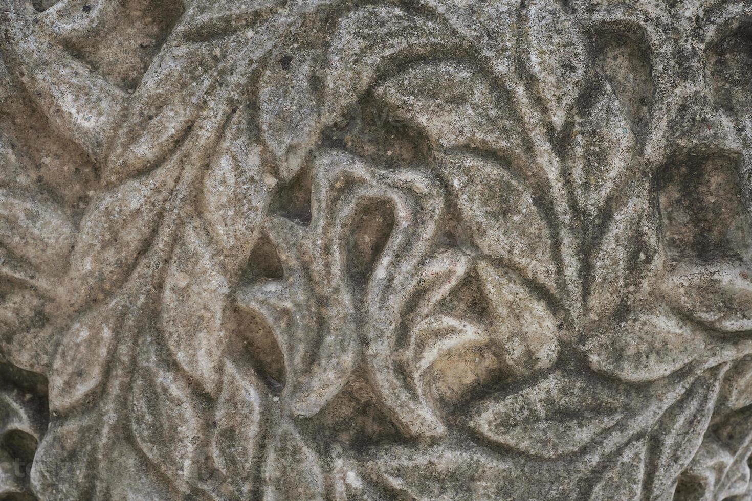 Details of carved stones on the top of the portico, beautiful stone carvings, history and heritage of ancient civilizations, details of a temple in the Aegean region of Turkey photo