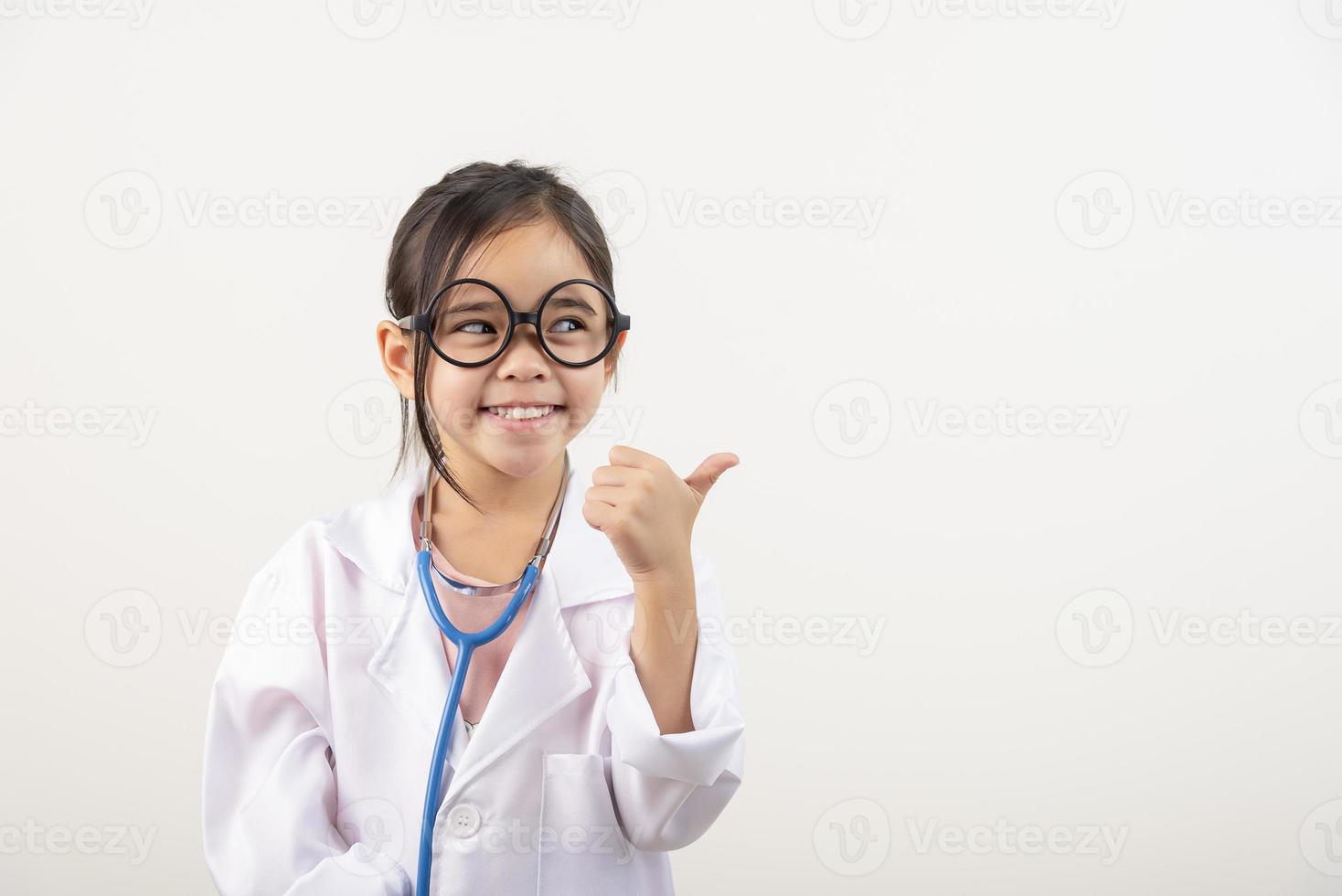 Asia little girl playing doctor isolated on white photo