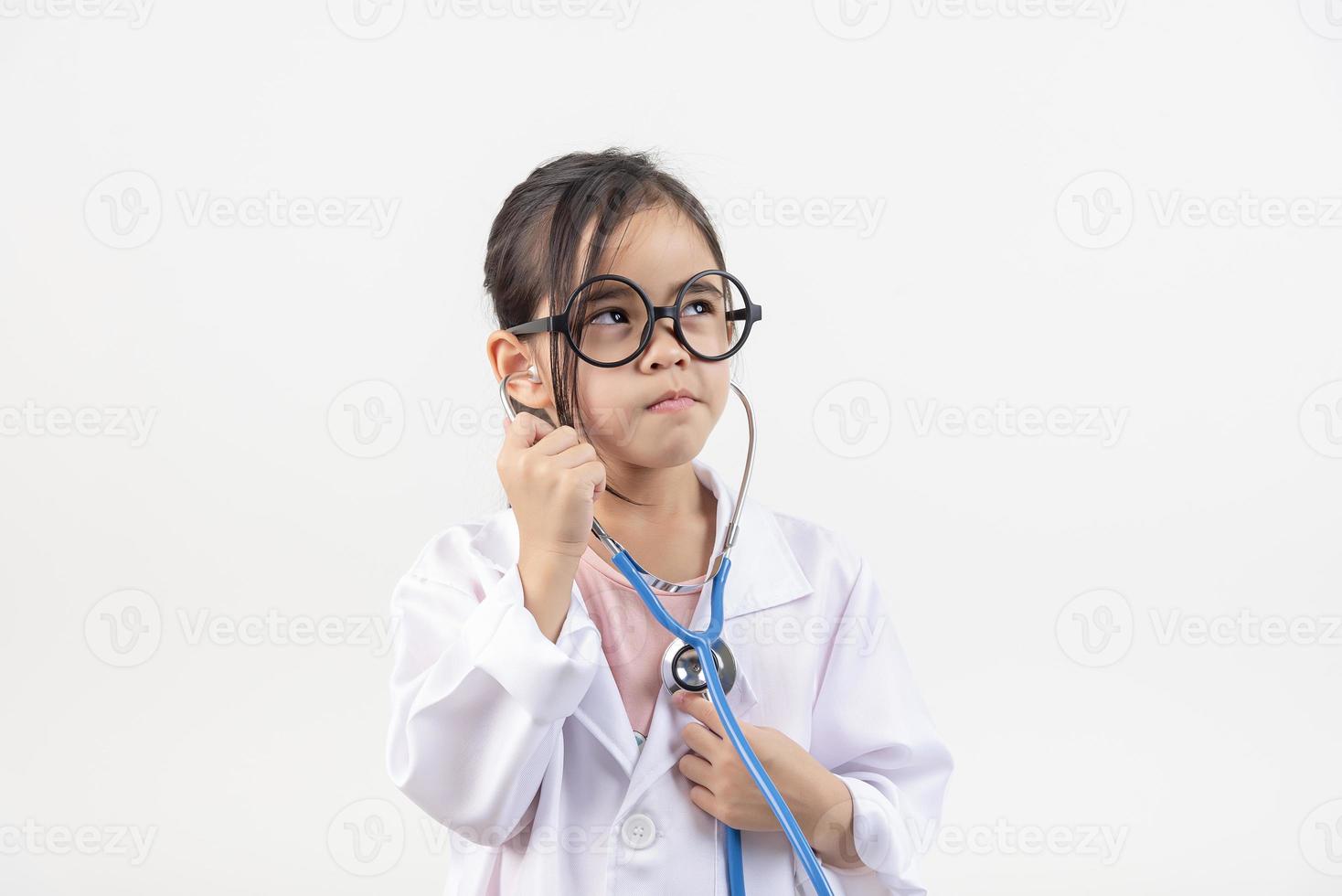 Asia little girl playing doctor isolated on white photo