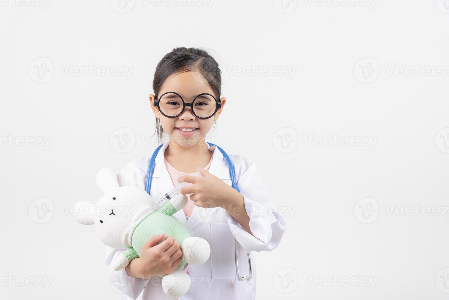 Asia little girl playing doctor isolated on white photo