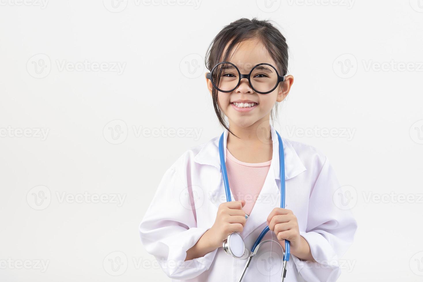 Asia little girl playing doctor isolated on white photo