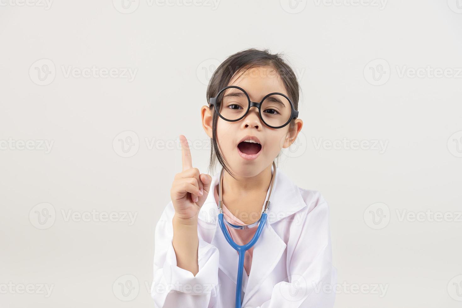 Asia little girl playing doctor isolated on white photo