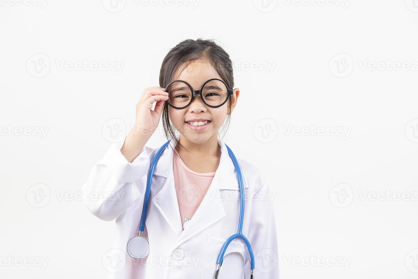 Asia little girl playing doctor isolated on white photo
