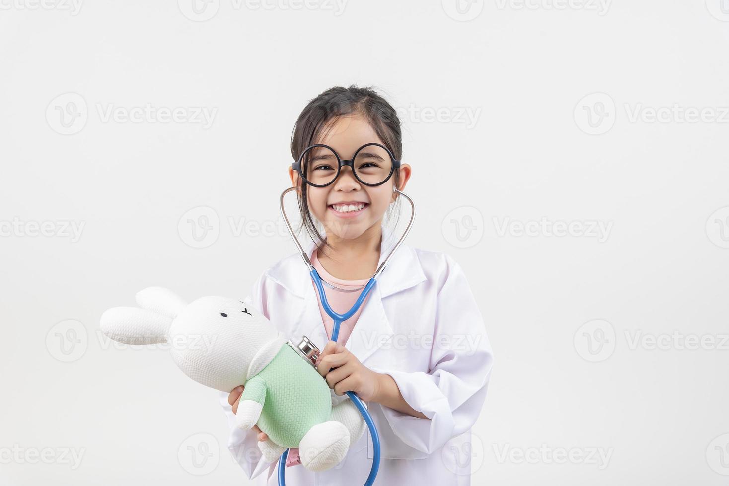 Asia little girl playing doctor isolated on white photo