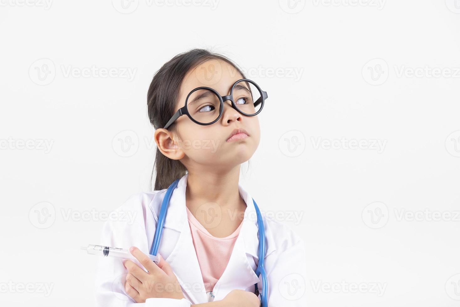Asia little girl playing doctor isolated on white photo