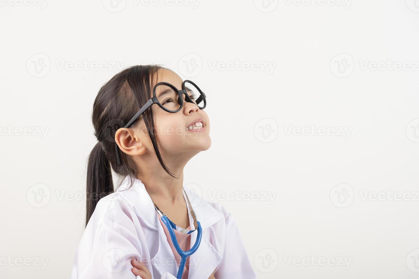Asia little girl playing doctor isolated on white photo