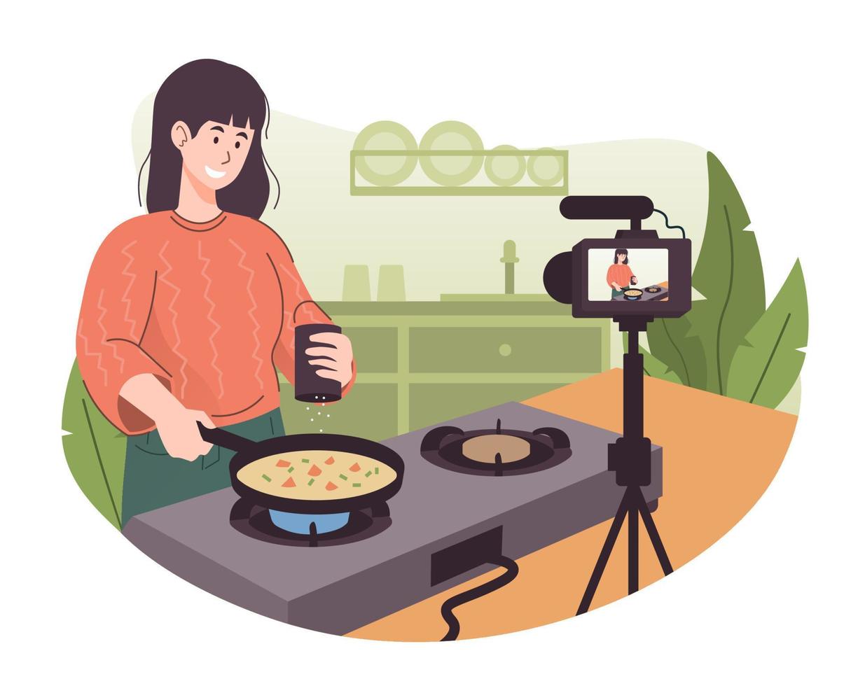 Female chef cooking in the kitchen while recording video using her camera for her online video channel. Food blogger preparing some food vector