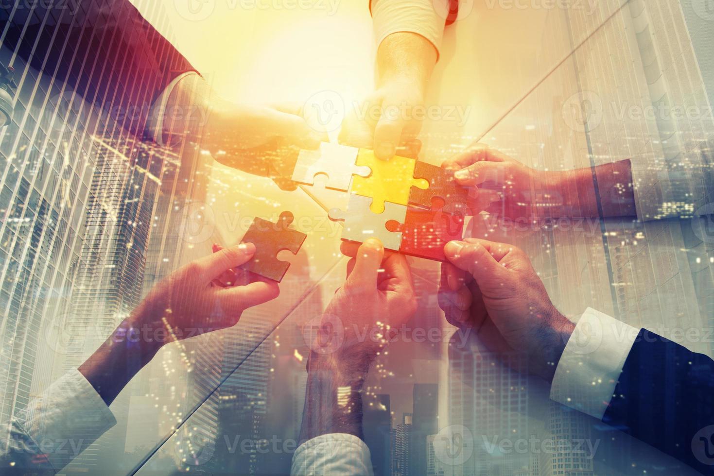 Teamwork of partners. Concept of integration and startup with puzzle pieces. double exposure photo