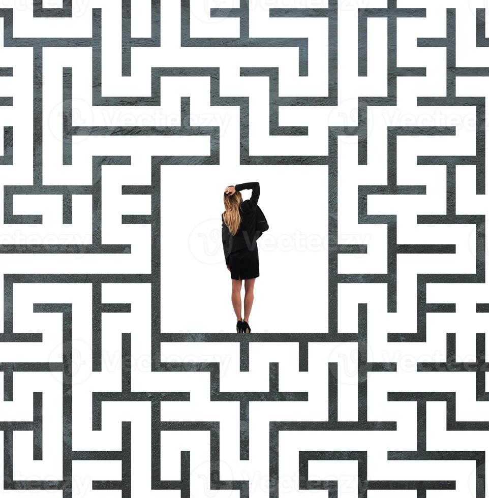 Confused businesswoman at the center of a maze photo