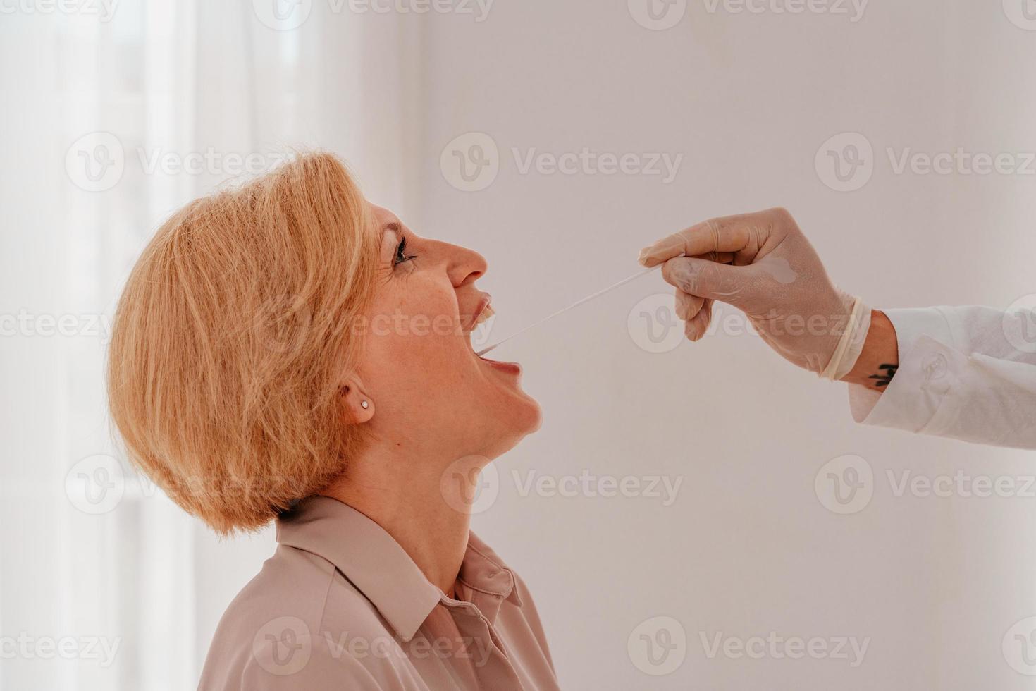 Doctor is checking the covid-19 virus with a tester photo