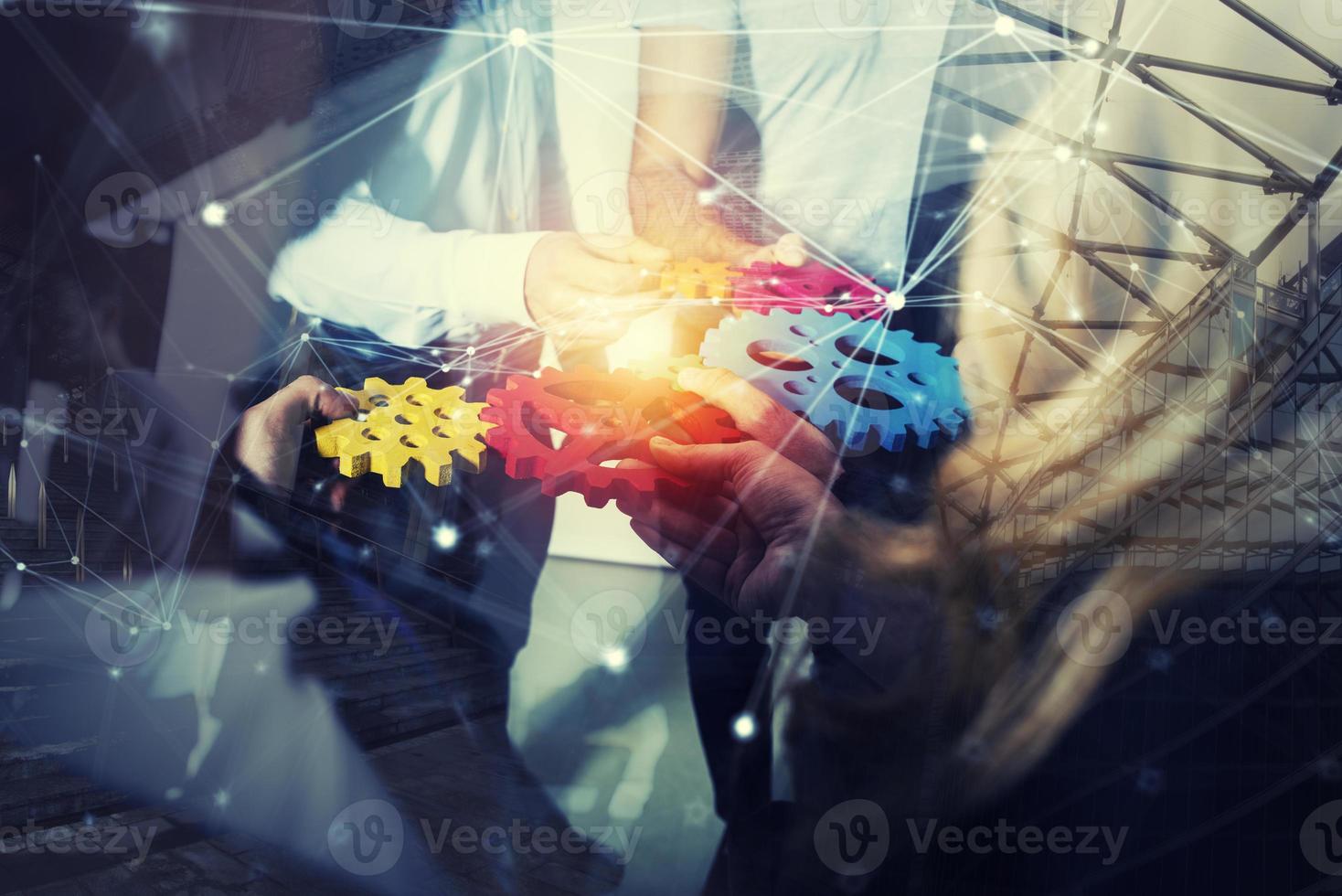 Business team connect pieces of gears. Teamwork, partnership and integration concept. double exposure with network effects photo