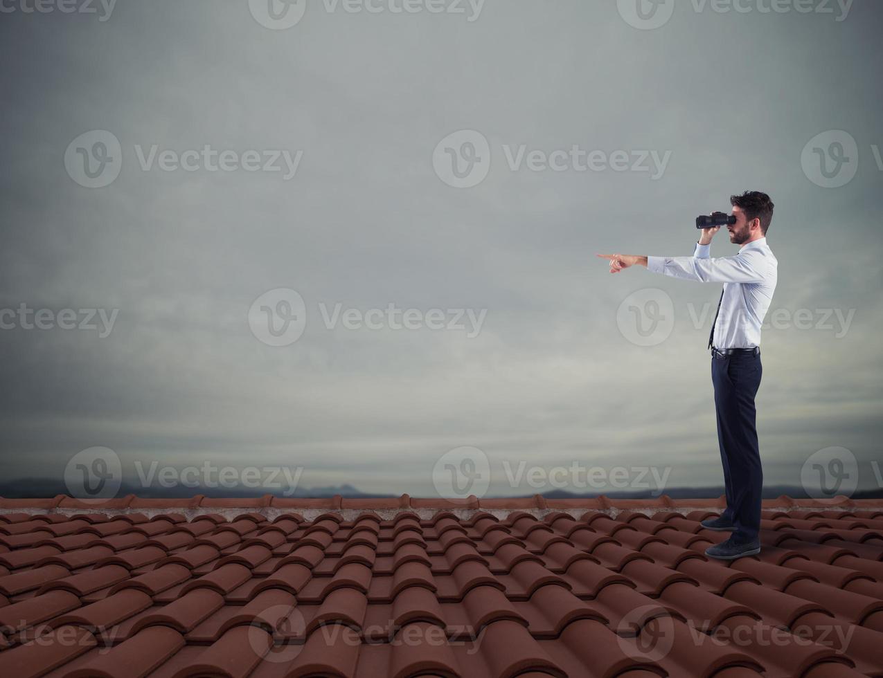 Businessman searchs for new horizon, new business opportunities photo