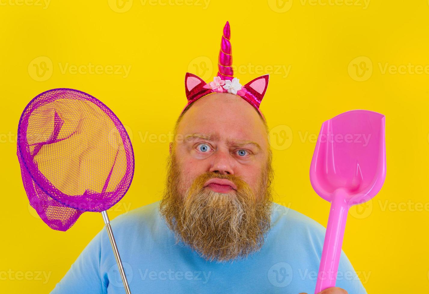 fat man with headband play with sea net and paddle photo